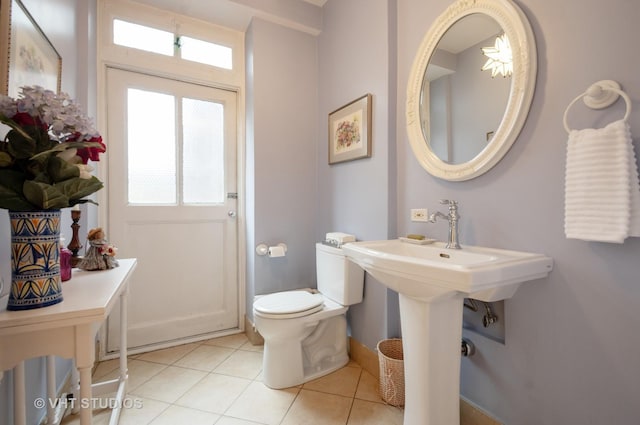 half bath featuring tile patterned flooring and toilet