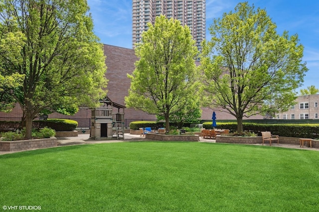 view of yard with playground community and fence