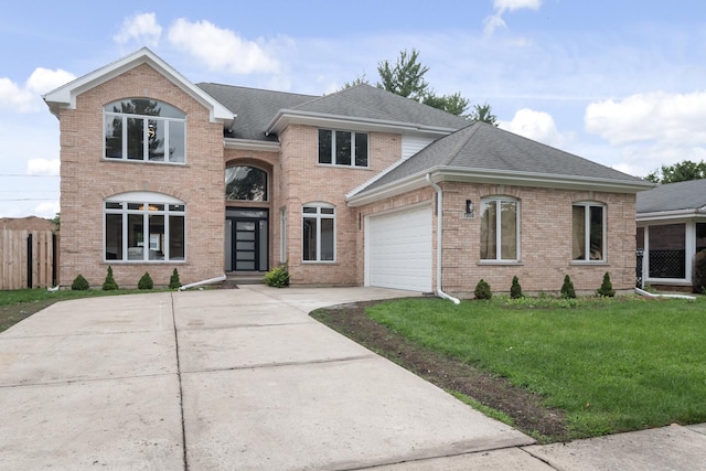 traditional home featuring brick siding, a shingled roof, concrete driveway, an attached garage, and a front yard