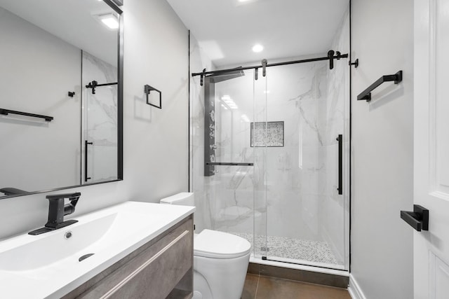 bathroom with vanity, a marble finish shower, and toilet