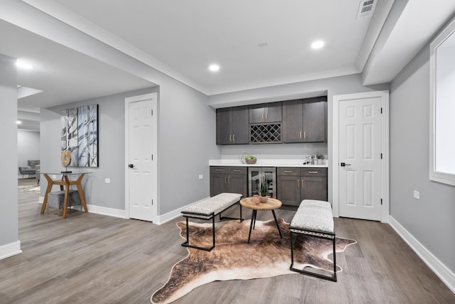 interior space with recessed lighting, wood finished floors, visible vents, baseboards, and a bar