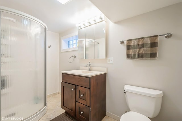 full bath with a stall shower, baseboards, toilet, tile patterned flooring, and vanity