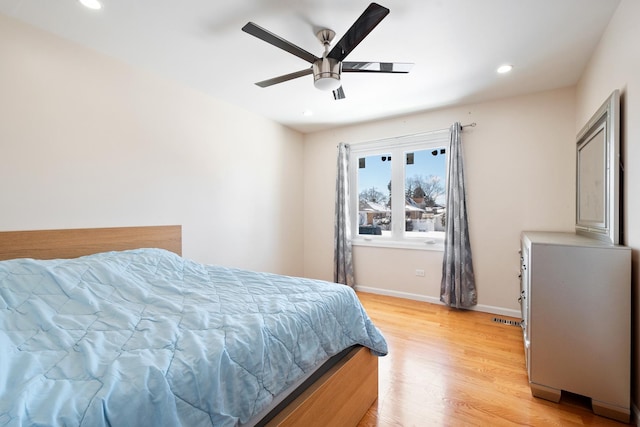 bedroom with light wood finished floors, recessed lighting, a ceiling fan, and baseboards