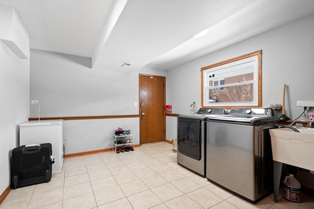 laundry area featuring light tile patterned flooring, laundry area, visible vents, baseboards, and independent washer and dryer