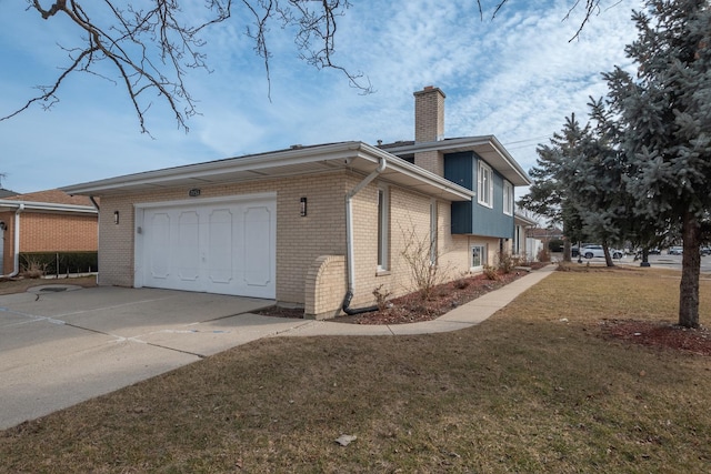 view of side of home featuring a garage, concrete driveway, a chimney, a yard, and brick siding