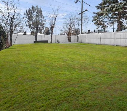 view of yard with a fenced backyard