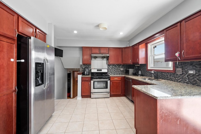 kitchen with light stone counters, light tile patterned floors, stainless steel appliances, a sink, and under cabinet range hood