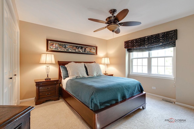 bedroom with carpet floors, baseboards, visible vents, and ceiling fan