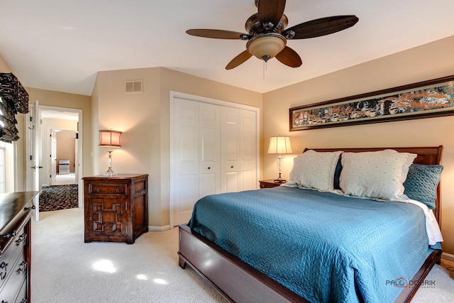 carpeted bedroom featuring a ceiling fan, a closet, visible vents, and baseboards