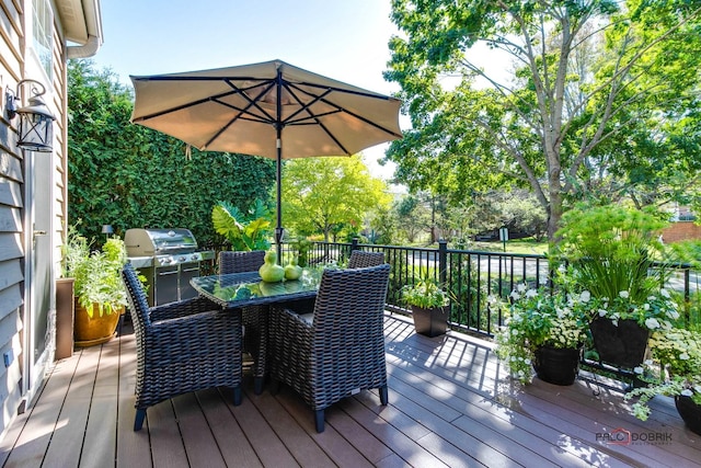 wooden terrace featuring outdoor dining space