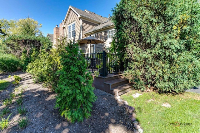 view of side of property with a wooden deck