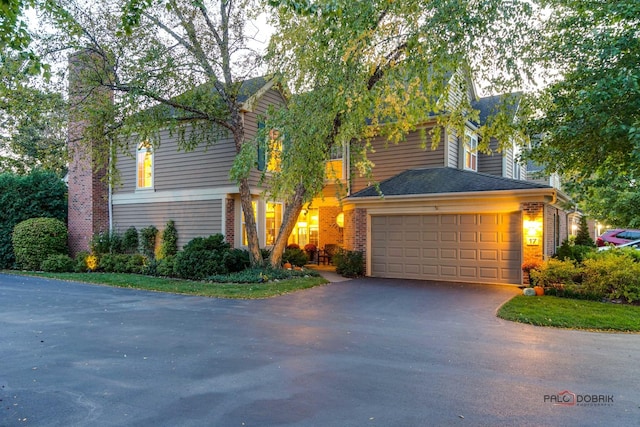 view of front of property with brick siding and aphalt driveway