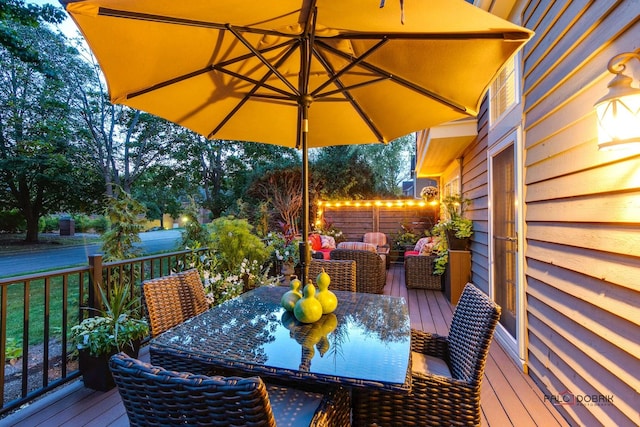 wooden terrace featuring outdoor dining area