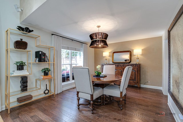 dining space with baseboards and wood finished floors