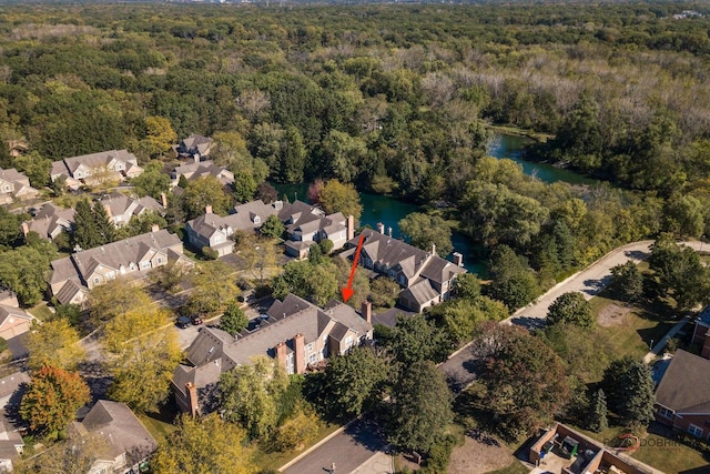 bird's eye view with a water view, a residential view, and a wooded view