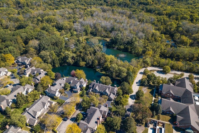 bird's eye view with a forest view, a water view, and a residential view