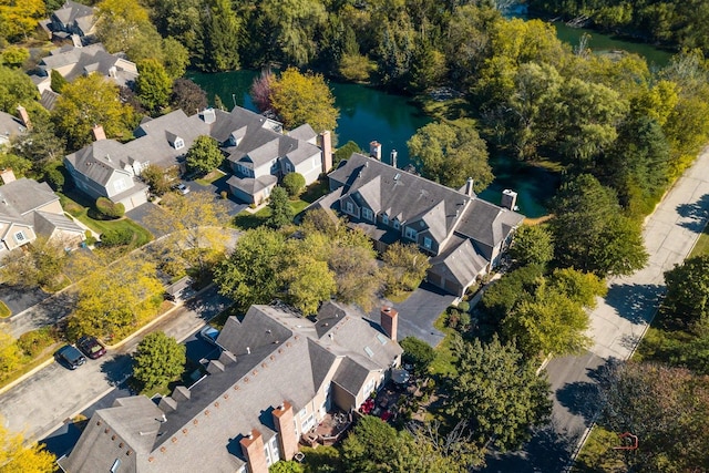 birds eye view of property with a water view and a residential view