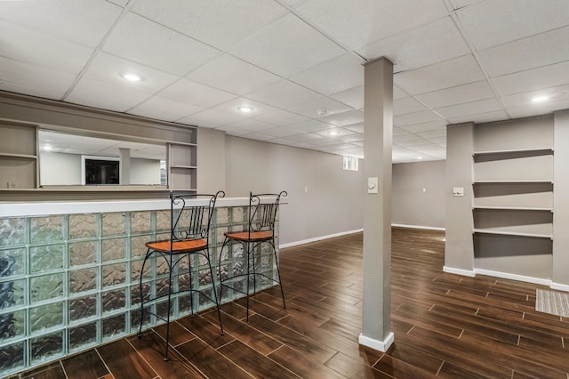 bar with recessed lighting, a drop ceiling, baseboards, and wood finished floors