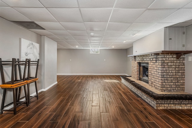 interior space with a fireplace, baseboards, and wood finished floors