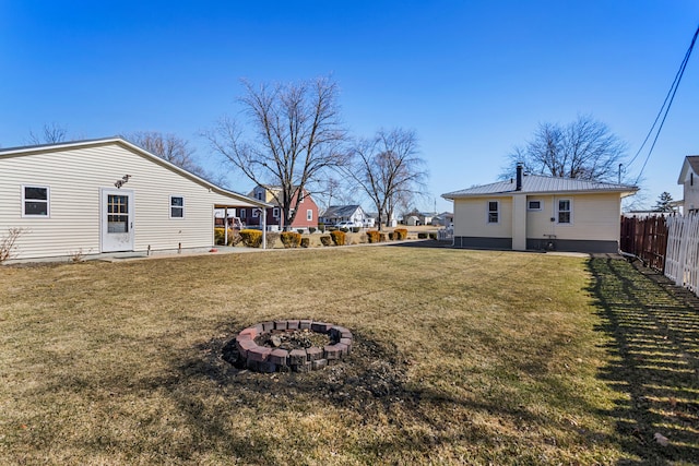 view of yard featuring an outdoor fire pit and fence