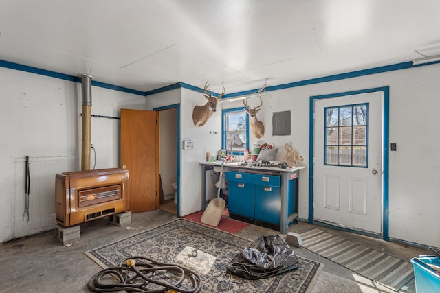 misc room with electric panel and unfinished concrete flooring