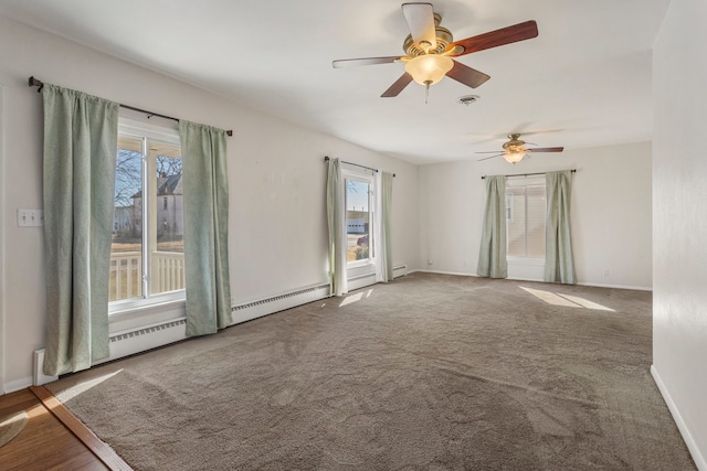 spare room with carpet, visible vents, and baseboards