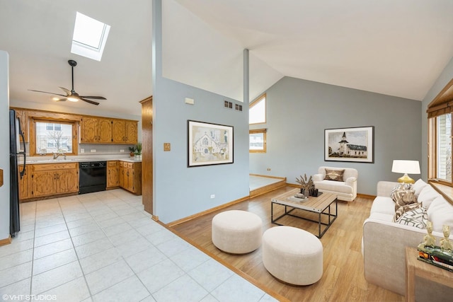 living area featuring a healthy amount of sunlight, a skylight, light wood-type flooring, and visible vents