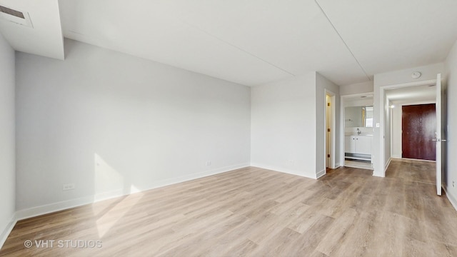 interior space featuring light wood-type flooring, baseboards, and visible vents