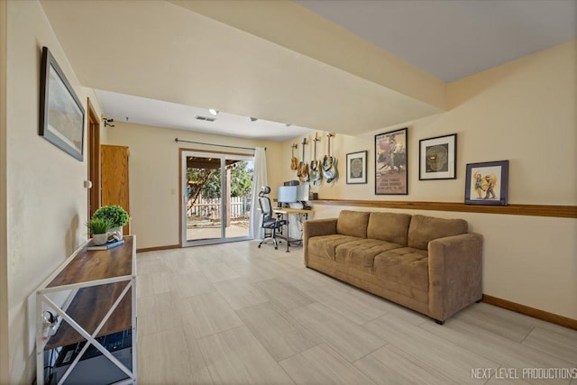 living area with visible vents and baseboards