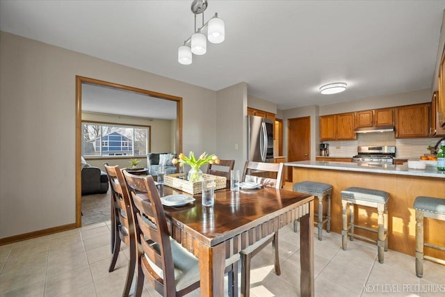 dining area featuring baseboards and light tile patterned flooring