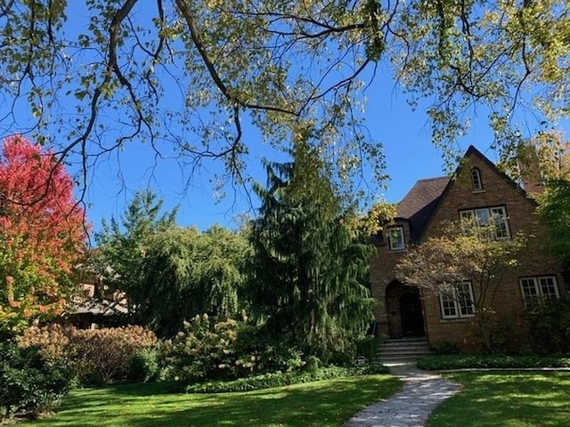 tudor-style house with a front lawn