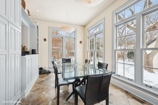 sunroom featuring a healthy amount of sunlight and visible vents