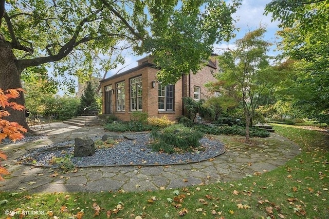 view of side of home featuring brick siding