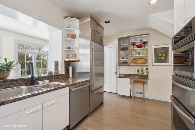 kitchen with white cabinetry, appliances with stainless steel finishes, open shelves, and a sink