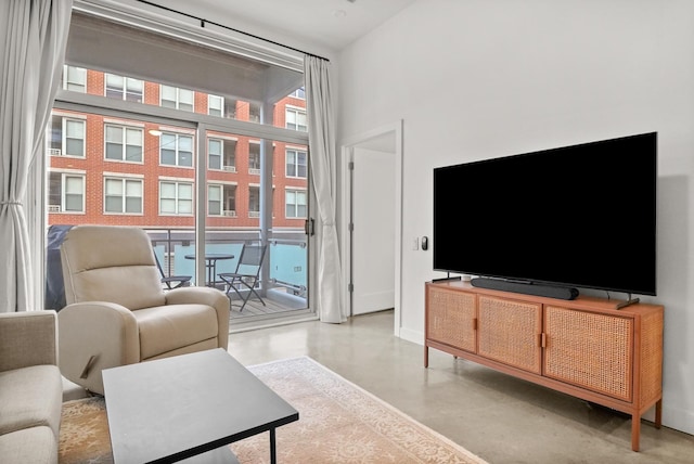 living room featuring concrete floors and baseboards