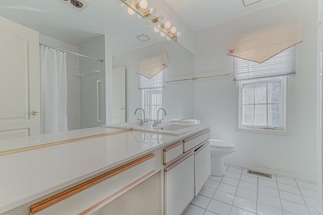 full bath featuring visible vents, plenty of natural light, toilet, and vanity