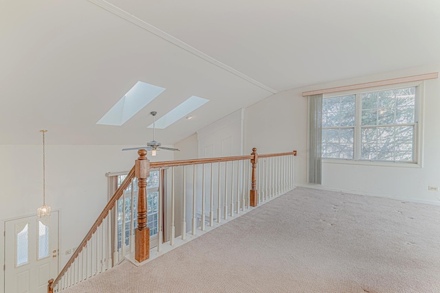 hall with lofted ceiling with skylight and carpet floors