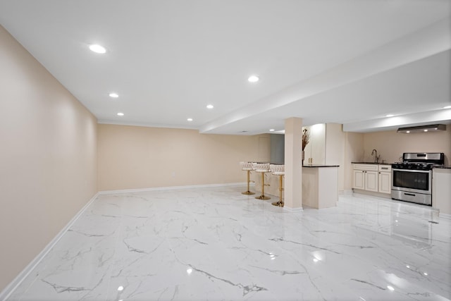 interior space with recessed lighting, a sink, baseboards, marble finish floor, and indoor wet bar