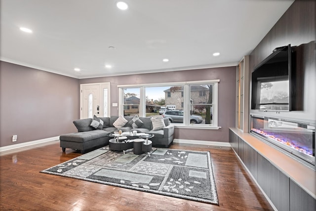 living room with a glass covered fireplace, recessed lighting, baseboards, and wood finished floors