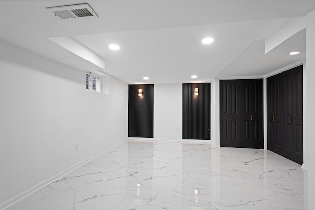 spare room featuring marble finish floor, visible vents, and recessed lighting