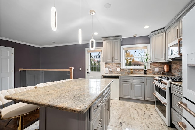 kitchen featuring gray cabinets, double oven range, dishwasher, and a sink