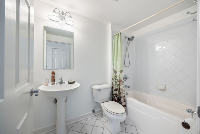 bathroom with tile patterned flooring, baseboards, shower / tub combo, and toilet