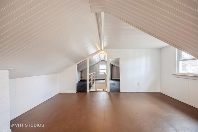 additional living space with lofted ceiling, a wealth of natural light, and finished concrete flooring