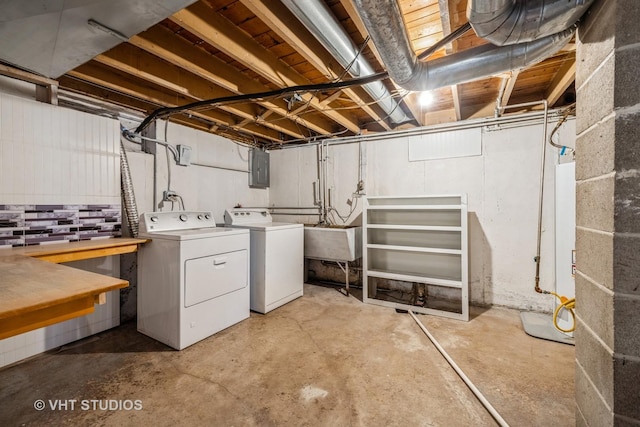 washroom with laundry area, independent washer and dryer, a sink, and electric panel