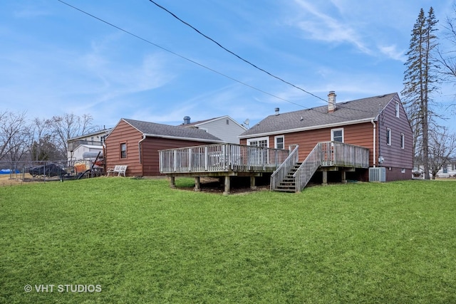 back of house featuring a deck, cooling unit, stairs, a lawn, and a chimney