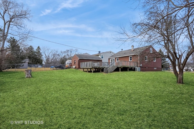 view of yard featuring a deck and fence