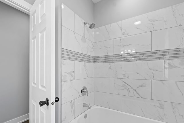 full bath featuring baseboards and shower / bathtub combination