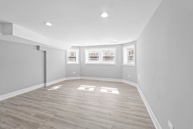 spare room with light wood-style flooring, baseboards, and recessed lighting