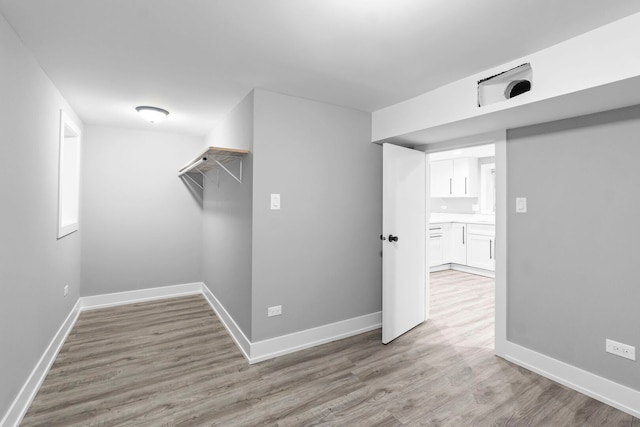 interior space featuring light wood finished floors and baseboards