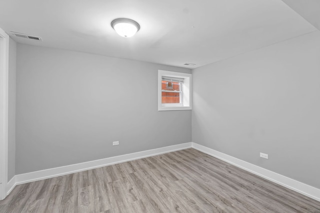 empty room featuring baseboards, visible vents, and light wood-style flooring